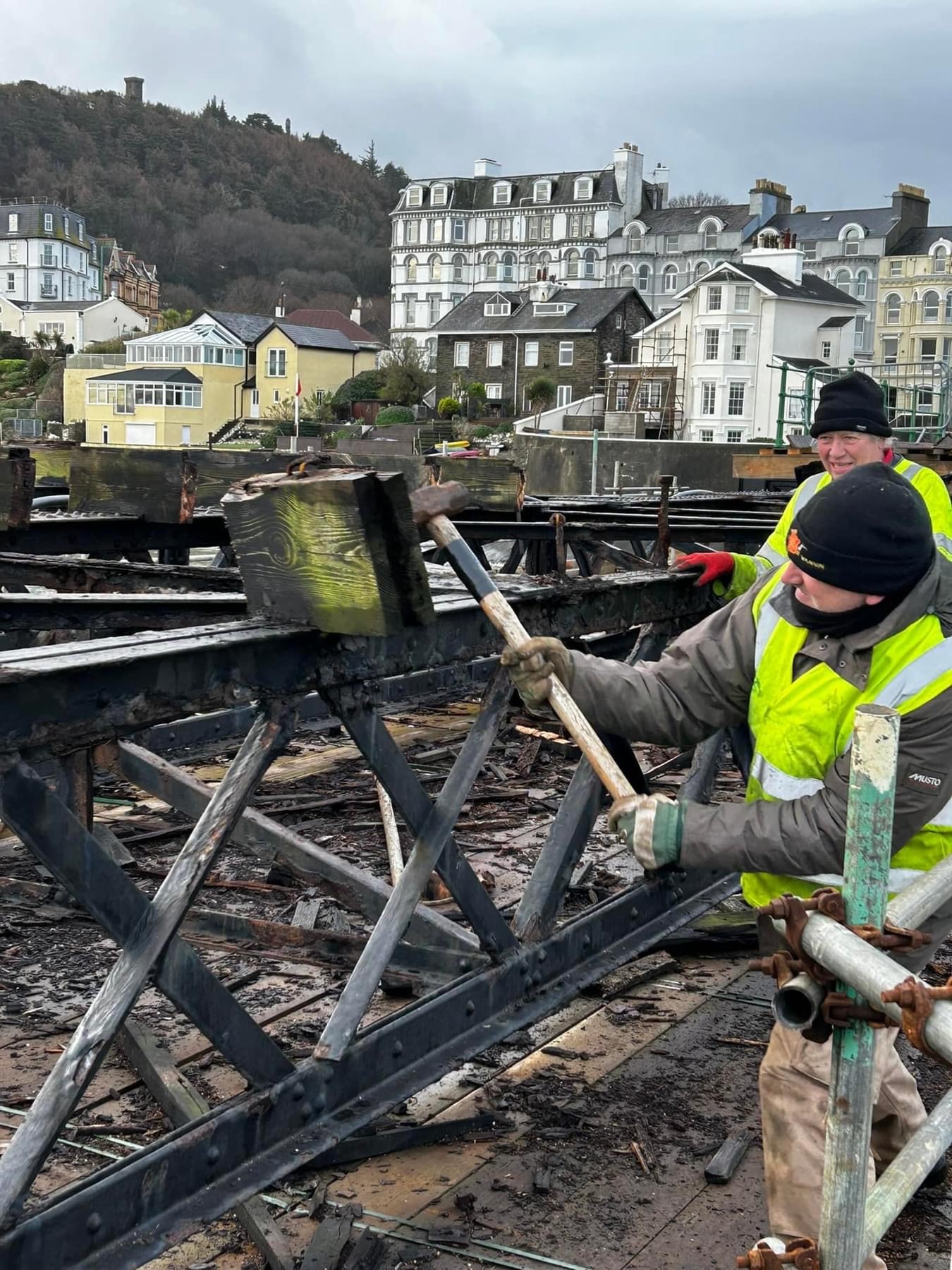 Volunteers remove timber from bay 8 of Queen’s Pier. Image: QPRT