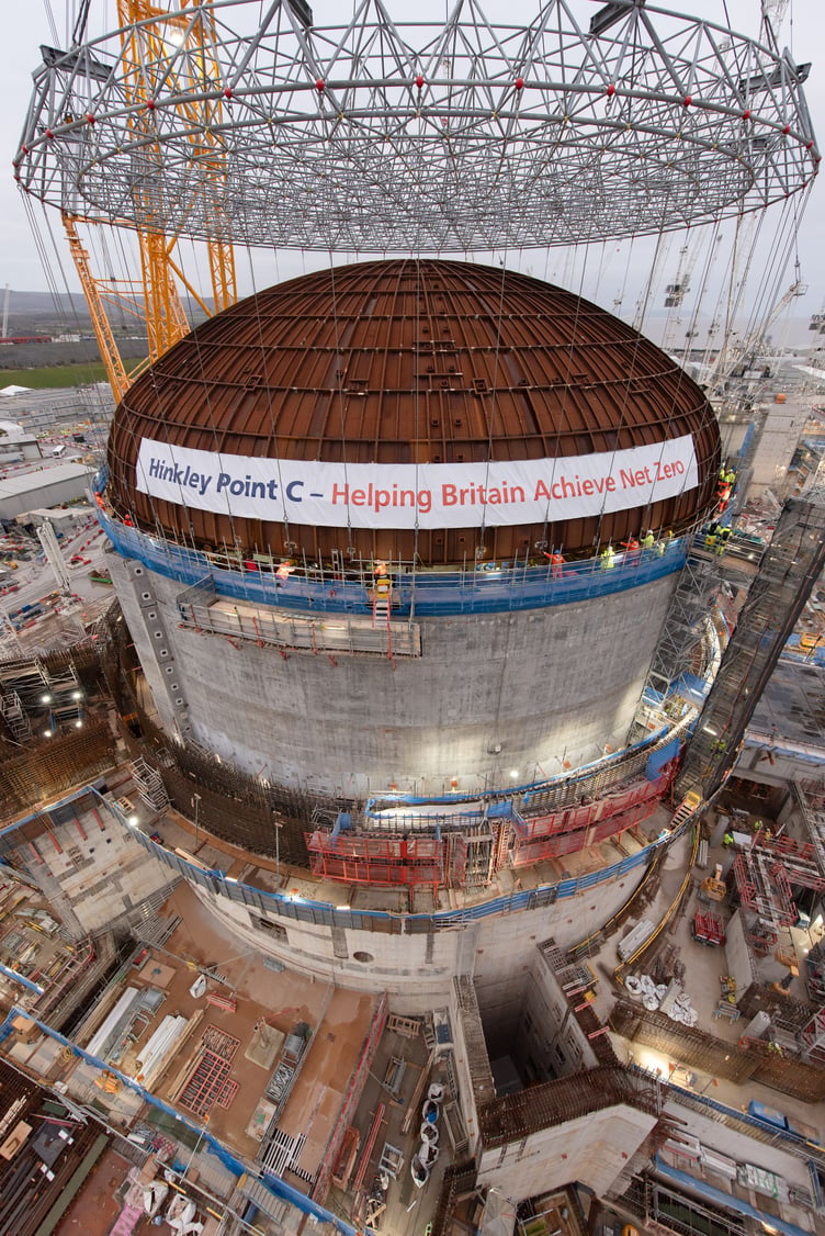 Gently does it as a huge dome rests on top of Hinkley C's first reactor building.