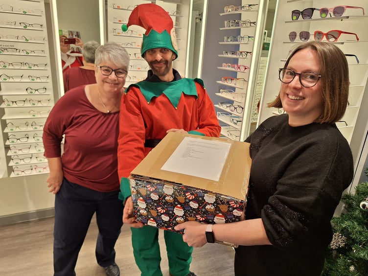 The Elf visits Specavers in Okehampton, above; and Bramhill Builders as he raises funds for Okehampton Community Kitchen’s Christmas lunches and food parcels.