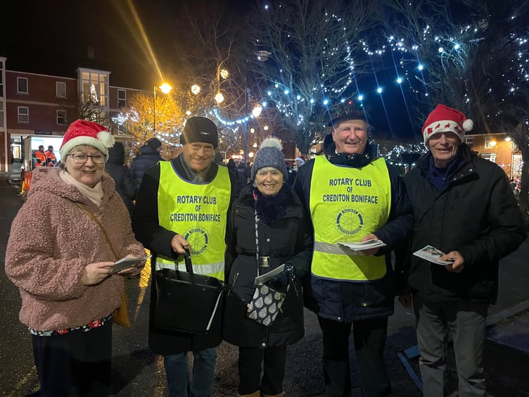 Buying a Carol sheet from members of the Rotary Club of Crediton. AQ 2463