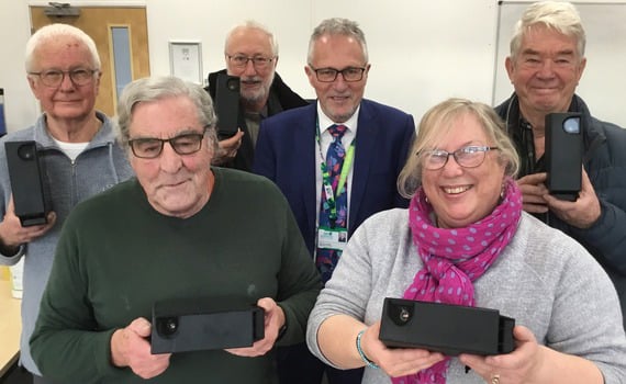 <p>Cllr Tony Costigan gives the first five sets of cameras to the parish council representatives</p>