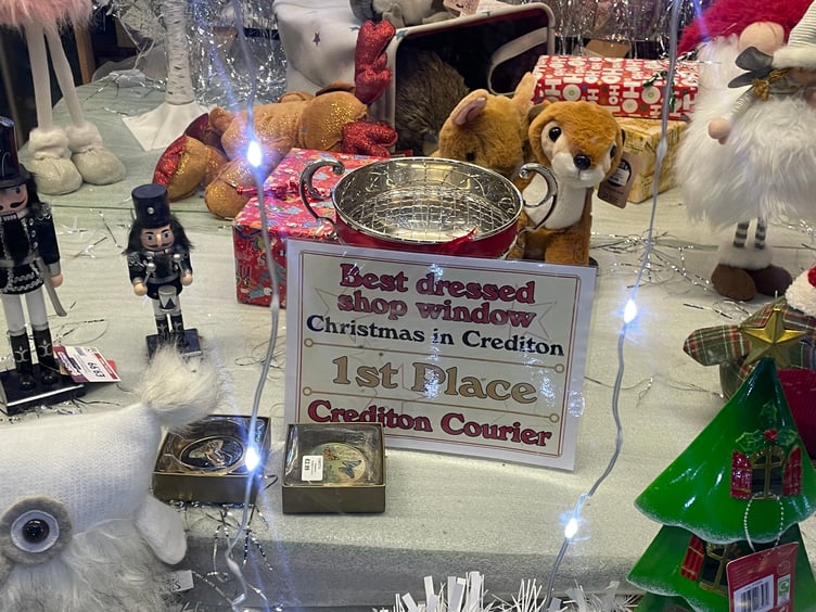 The trophy and certificate in the window at Adams Home Hardware. AQ 2459