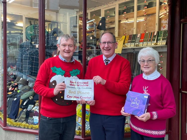 A E Lee (Outfitters) were placed third in the competition, presented by Alan Quick, Editor of the Crediton Courier, to proprietor Simon Lee and assistant Margaret Kenshole. AQ 2456
