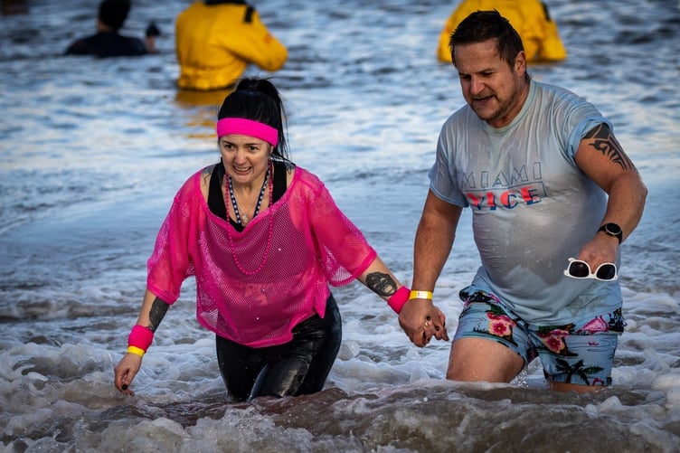 A colourful pair leaving the water at Minehead Beach.