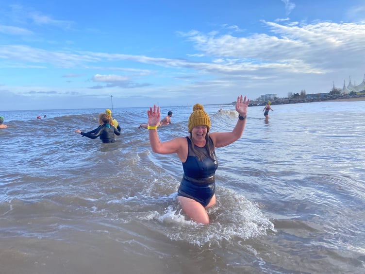 A participant cheers as she completes her dip.