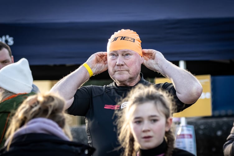 A brave swimmer preparing for her icy dip in the sea at Minehead.
