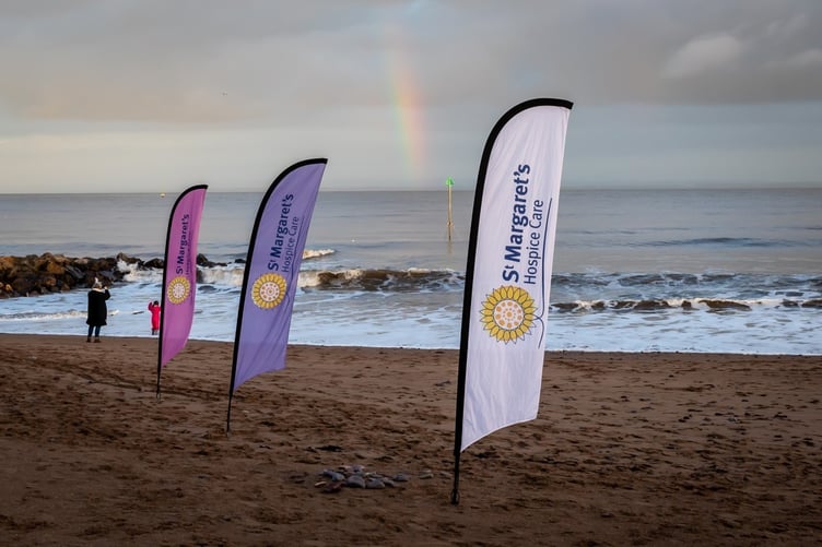 St Margaret's flags adorn Minehead Beach for the New Year's Day dip.