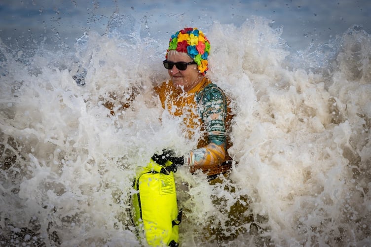 A swimmer enters the water with a splash.