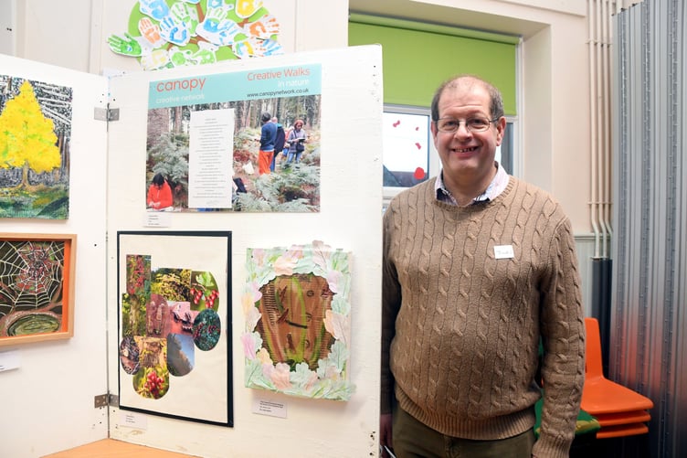 Jules Bastin with a photograph entitled Regeneration and a drawing The Forest Recovering and Healing the Scars of its Industrial Past.