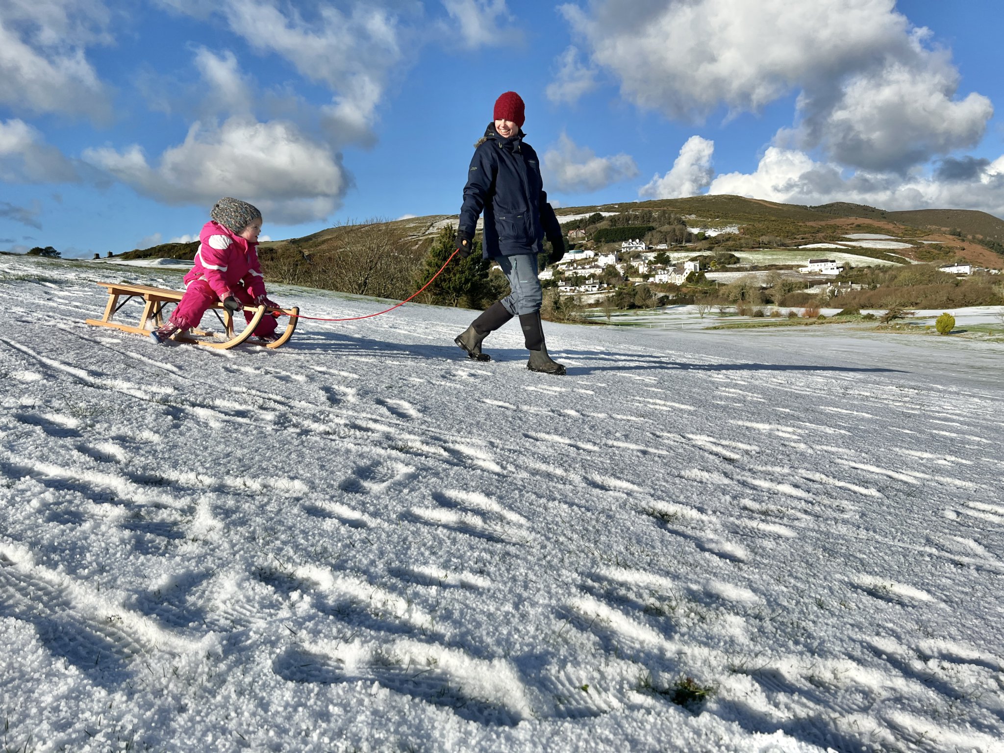 Ella Darbyshire, three, and mum Jackie enjoy a spot of tobogganing at Rowany, Port Erin