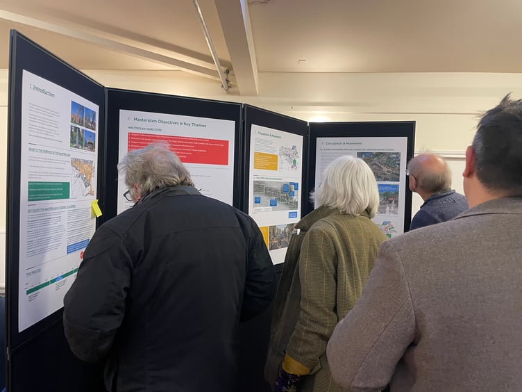 Members of the public looking at the Masterplan consultation documents. AQ 3606