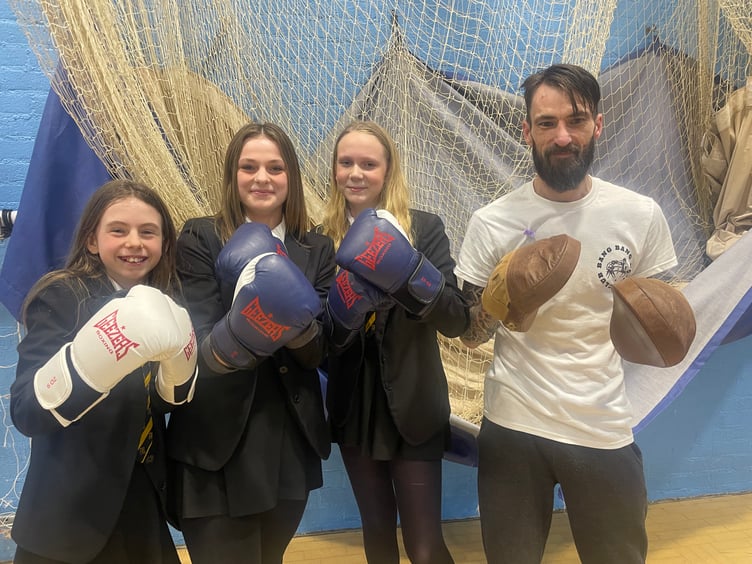 Jamie Parker of Bang Bang Boxing is pictured with some students who took part in a mini session. AQ 4137