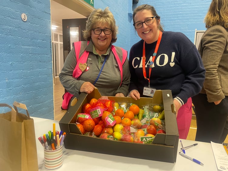 Hazel Evely, Crediton Morrisons Community Champion took along lots of fruit for those attending, pictured with Town Clerk Rachel Avery. AQ 4128