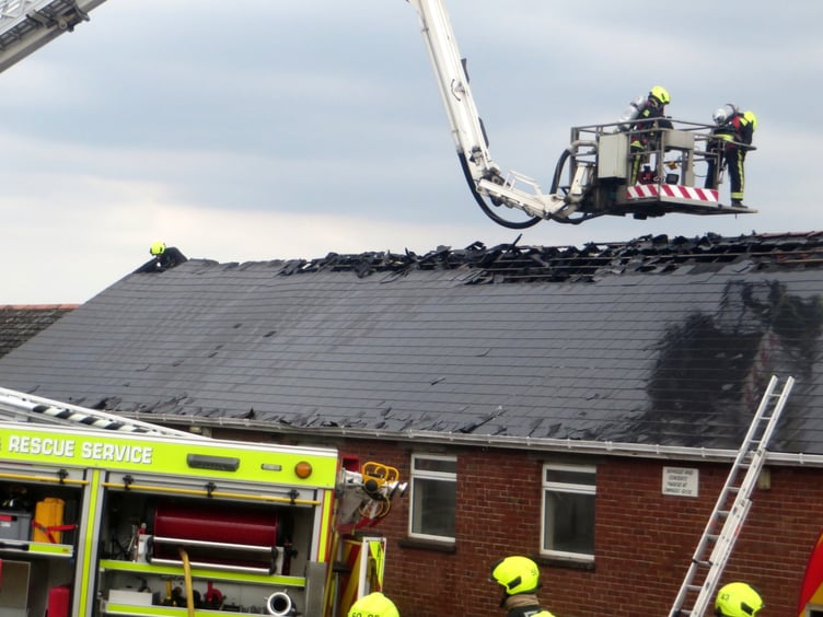 Fire crews at work at the burning Village Hall in September 2022. SR 2917