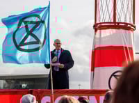 <p>Tilford's Colin Shearn, founder of the Farnborough Noise campaign group, addresses protesters at Extinction Rebellion's march against Farnborough Airport's expansion</p>