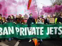 <p>Former airline pilot Todd Smith (right) leads an Extinction Rebellion march to Farnborough Airport alongside Greta Thunberg</p>