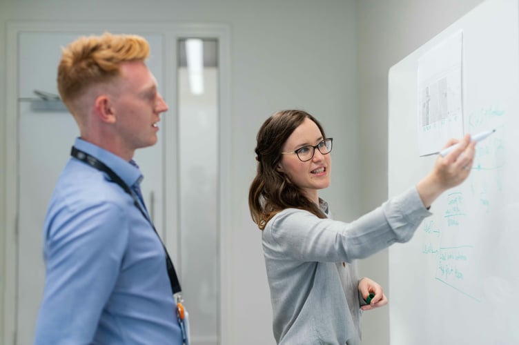 Female electronics engineer in meeting with colleague Empoweing Empowered Women Images & Pictures Successfull Female Working Woman Success Female Software Engineer Tools Female Engineer People Images & Pictures Business Work People Images & Pictures Glasses Accessories Accessory Apparel Clothing Backgrounds
