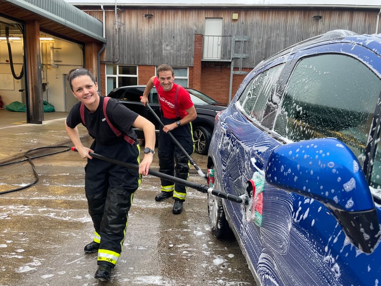 Firefighters busy at the car wash. AQ 4890