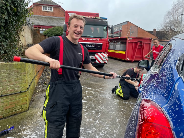 Firefighters busy at the car wash. AQ 4893