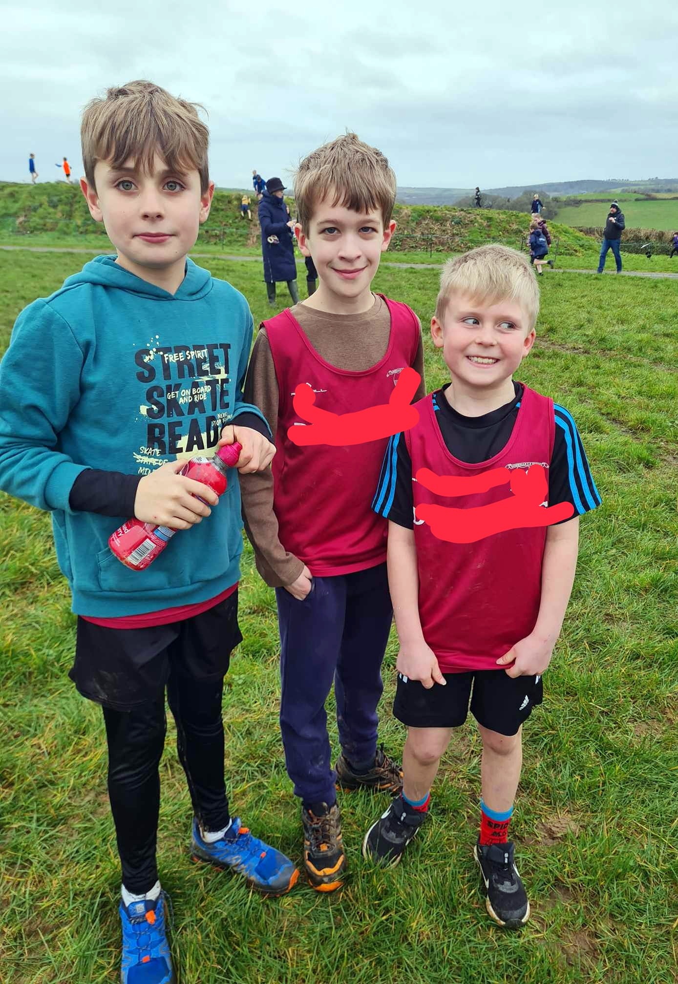 Boys recovering after a long and muddy race