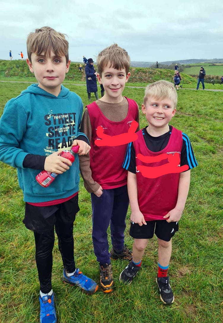 Boys recovering after a long and muddy race