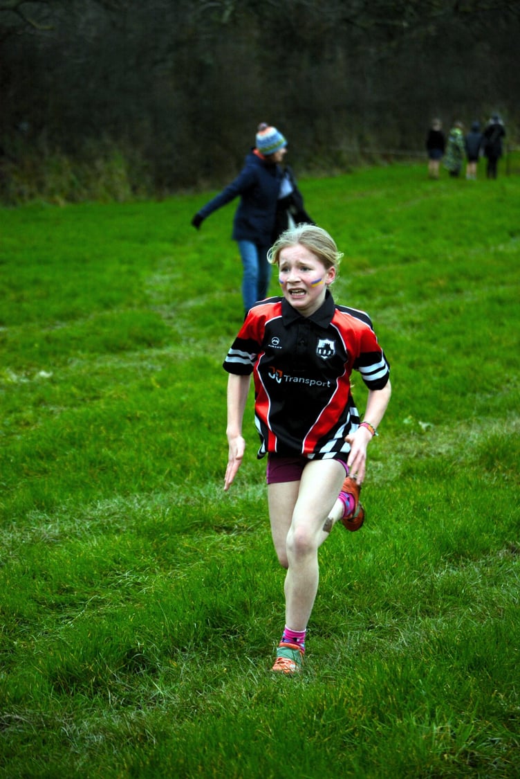 Year 3 and 4 girl at the end of her race