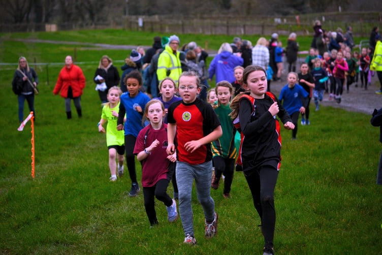 Year 3 and 4 girls fighting for the top places at the finish line
