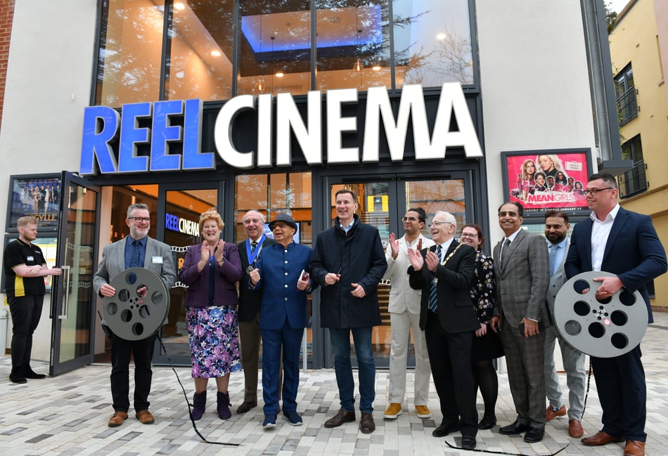 <p>Chancellor Jeremy Hunt cuts a film reel to open Farnham's new REEL Cinema</p>