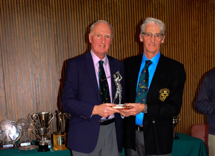 Seniors captain, Jim Dunlop, right, presenting John Cann with the John Baird Trophy.
