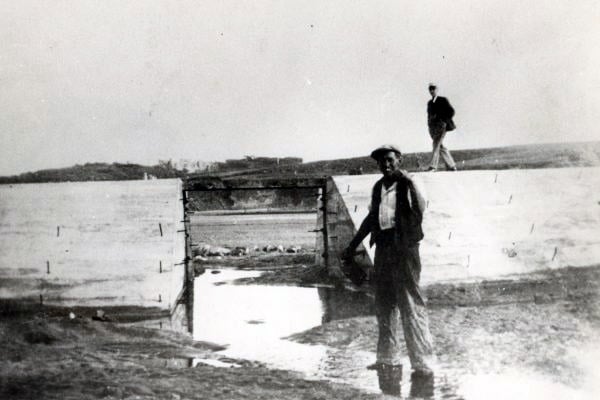 A worker gives a cheeky smile to the camera during the site's construction