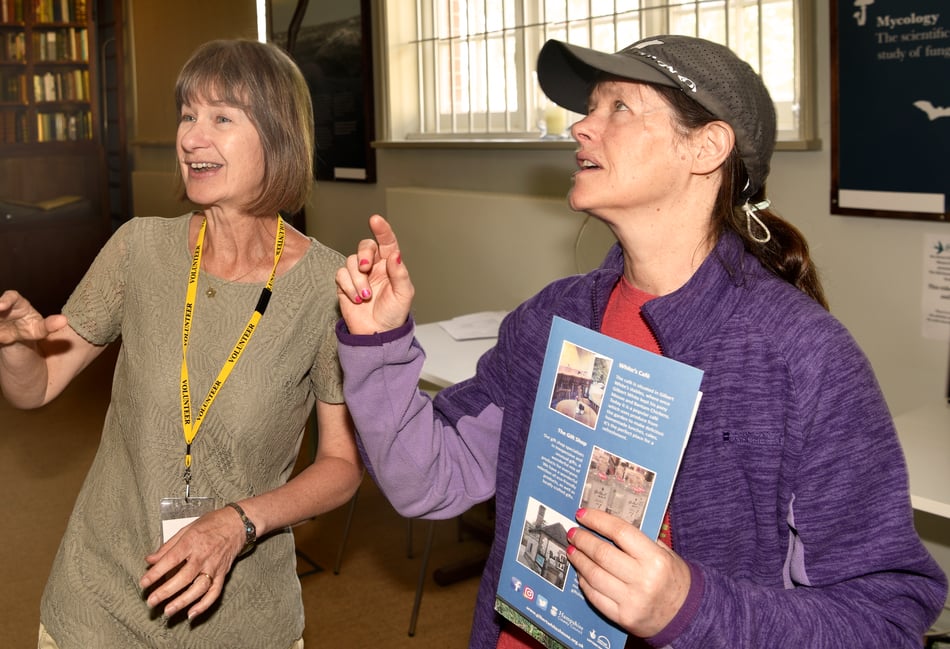 <p>Debbie Vodden, a volunteer at Gilbert White’s House, helps a visitor</p>