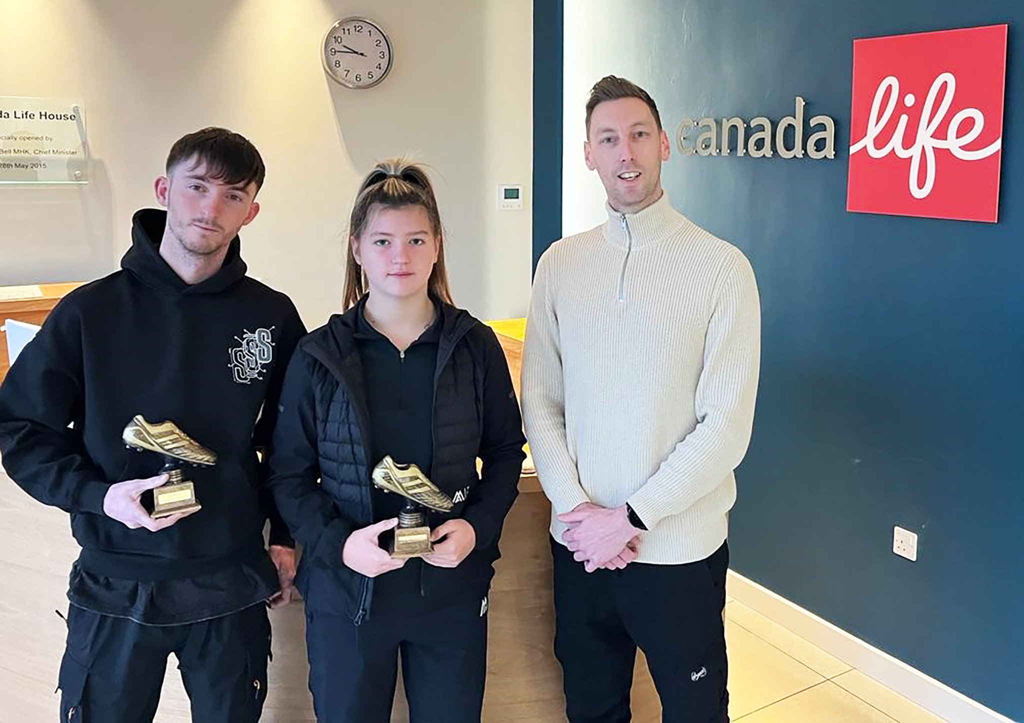 Young Players of the Month Milly Dawson and Dom McHarrie (left) receive their awards from Canada Life’s Dan Pownall