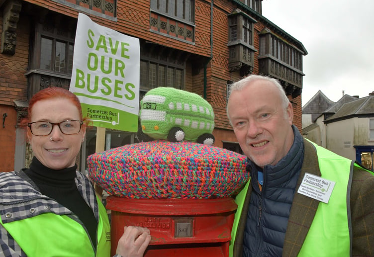 Somerset Bus Partnership co-chairman David Northey (right) with a bus-themed red post box topping in Wiveliscombe.