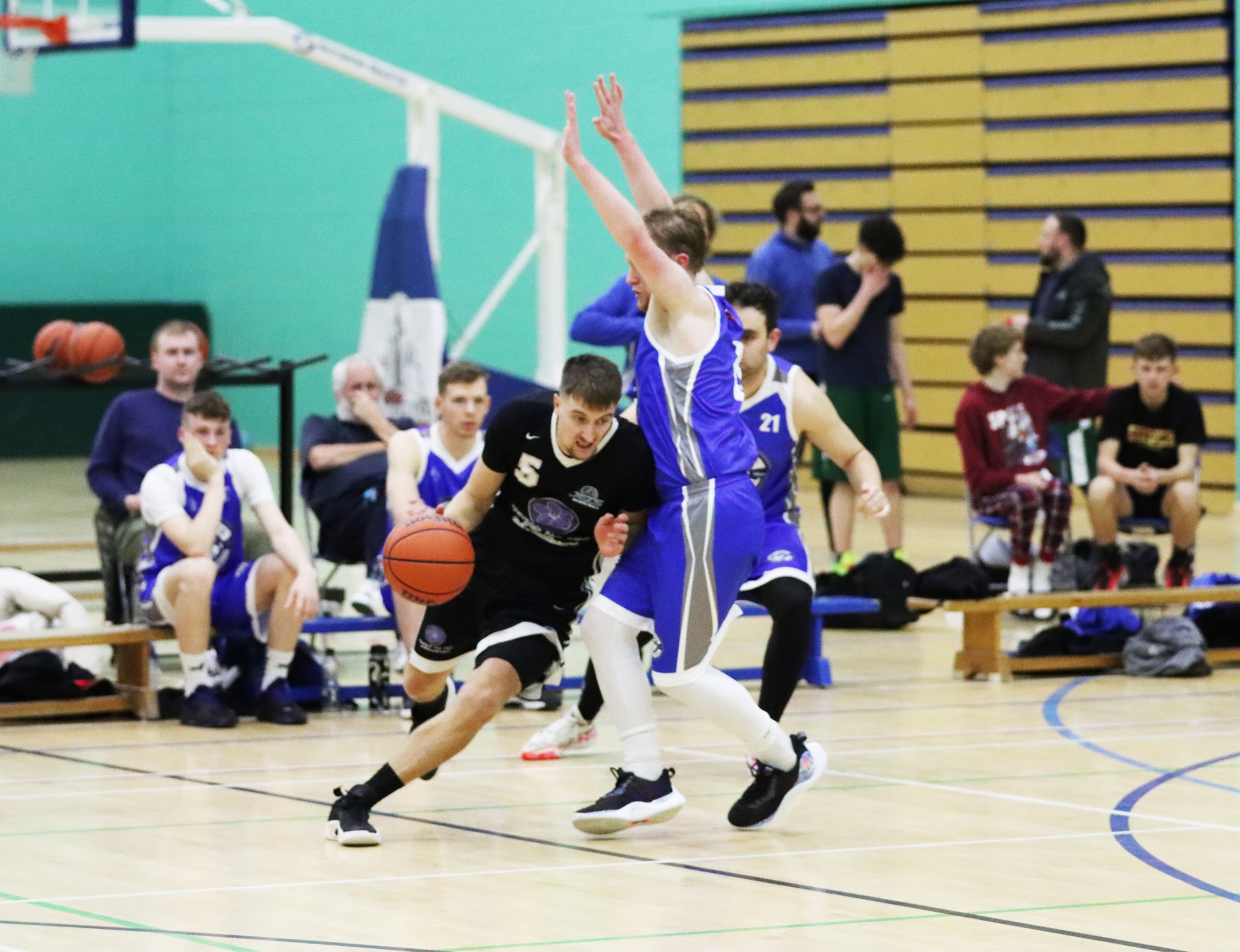 Jets’ Jake Glover tries to dribble under defensive pressure from Wolves’ Michael Pardoe. Solid defence helped the latter side claim a solid 75-44 victory over Jets at the NSC last Thursday evening to go top of the table