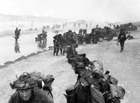 <p>Troops of 3rd Infantry Division on Queen Red beach, Sword area, circa 0845 hrs, June 6, 1944. In the foreground are sappers of 84 Field Company Royal Engineers, part of No.5 Beach Group, identified by the white bands around their helmets. Behind them, medical orderlies of 8 Field Ambulance, RAMC, can be seen assisting wounded men. In the background commandos of 1st Special Service Brigade can be seen disembarking from their LCI(S) landing craft.</p>