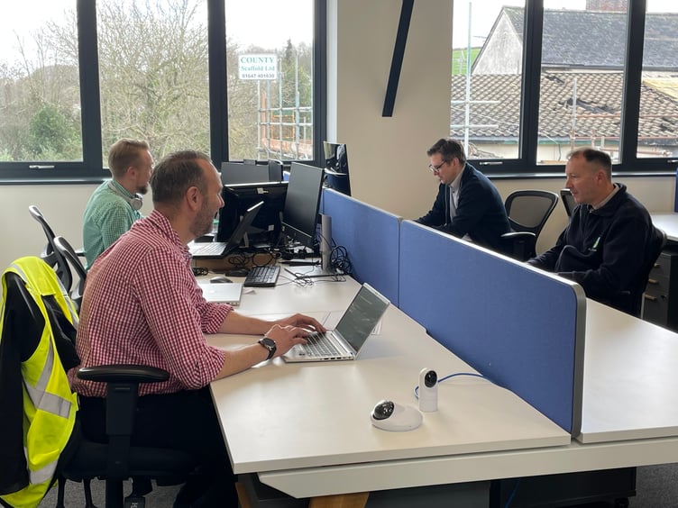 Staff working in the new open plan office. AQ 5469