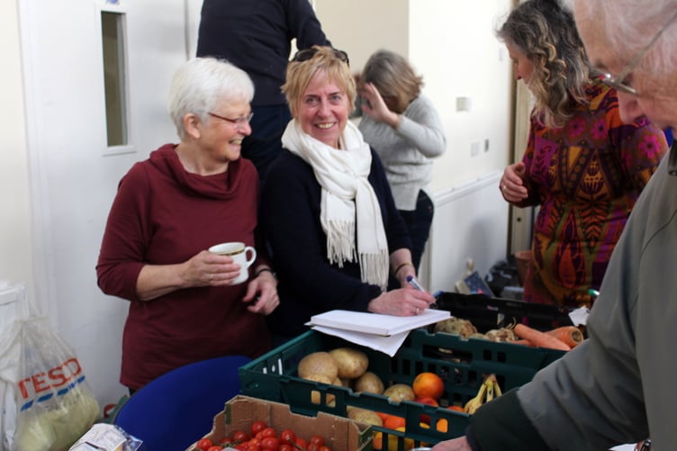 Alison Orchard and helper with the Food Share stand. SR 9509