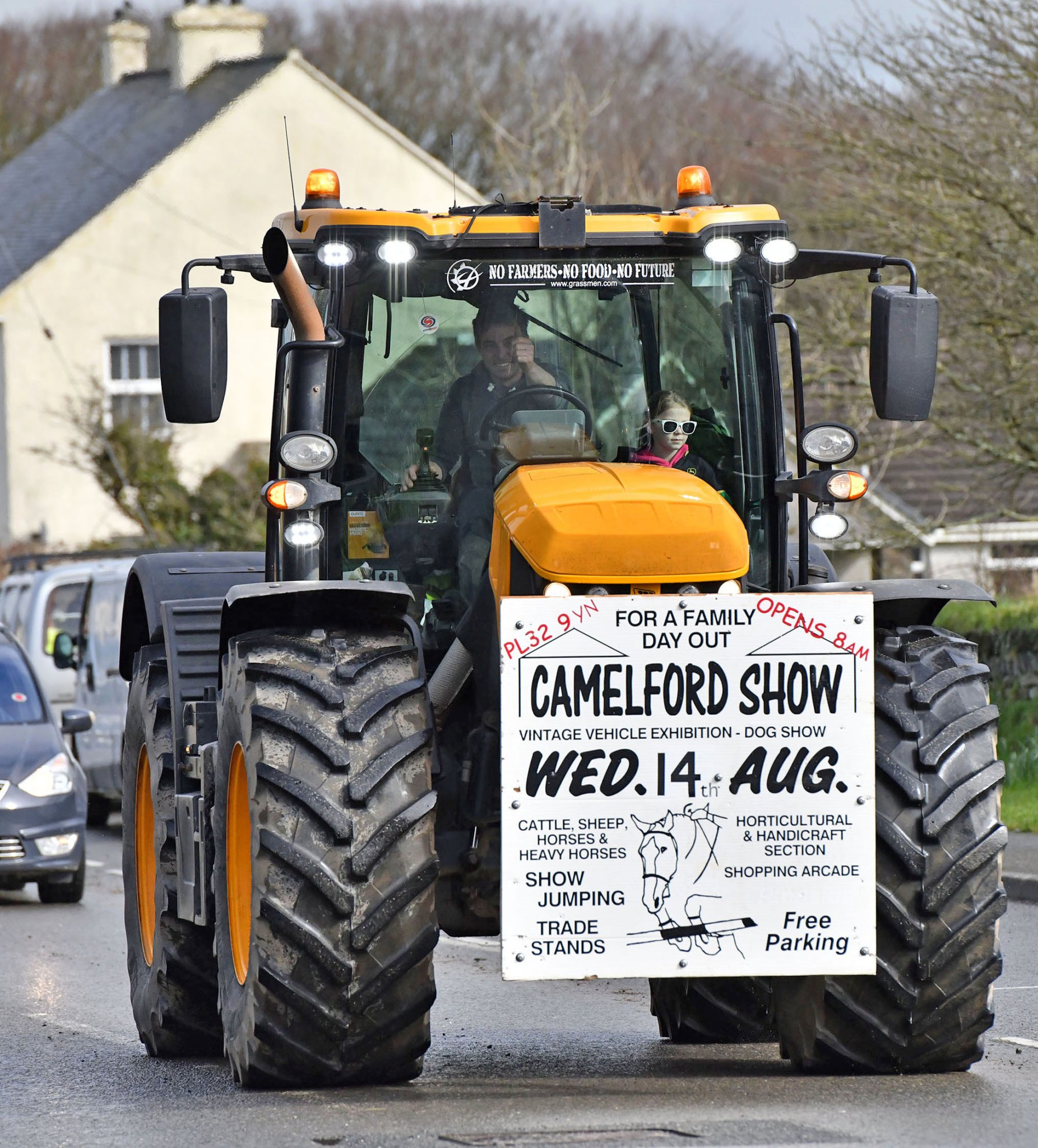 Giving thumbs up going through Delabole is Daniel Ward on The JCB Fastrac