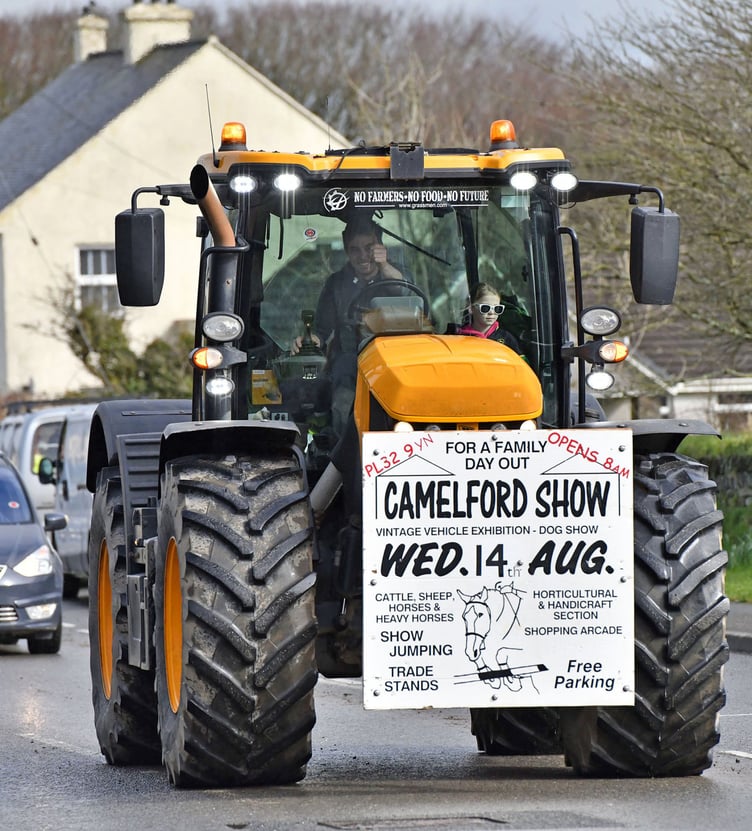 Giving thumbs up going through Delabole is Daniel Ward on The JCB Fastrac