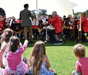 Children watching a live band at the Fayre.
