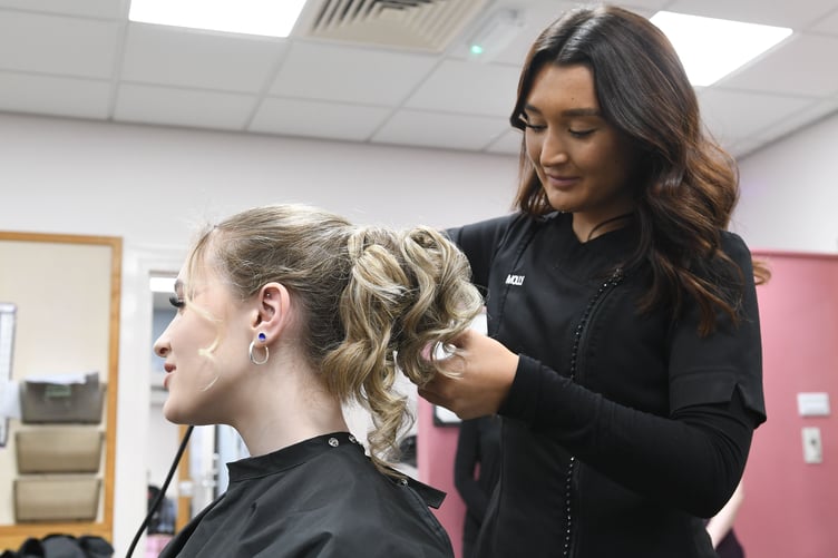 Lucy Kenyon, first year Level 1 Hairdressing student (left), and Molly Cromwell, second year Level 2 Hairdressing student, taking part in the hairdressing challenge at the Synnova salon on the UCM campus