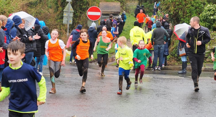 Spectators waited in the rain to support their friends and family