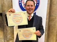 <p>Christian Barrington proudly holds the two British Pie Awards certificates</p>