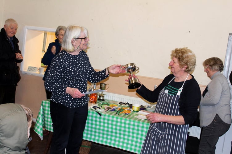 Margaret Harris, right, receives the cup from Erica Eden for most points in the Home Craft classes. SR 9561