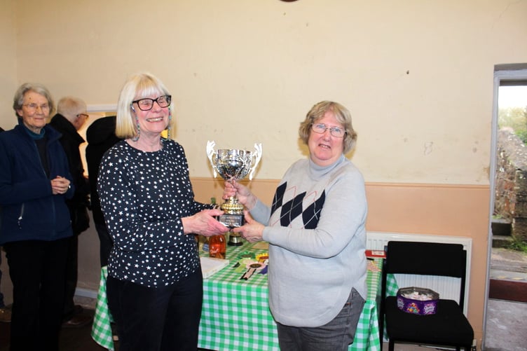 Sue Down, right, receives the cup from Erica Eden for most points in the flower section. SR 9560