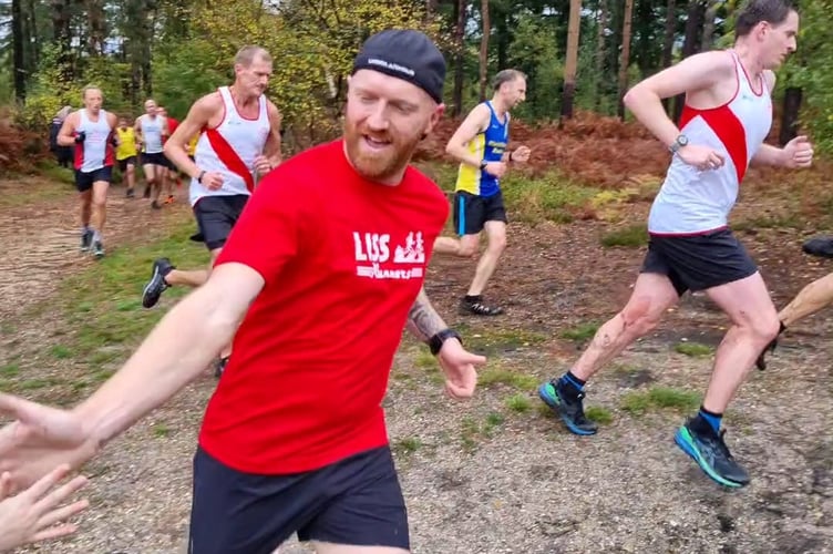 Liss Runners team captain Steve Armstrong gives a supporter a high five