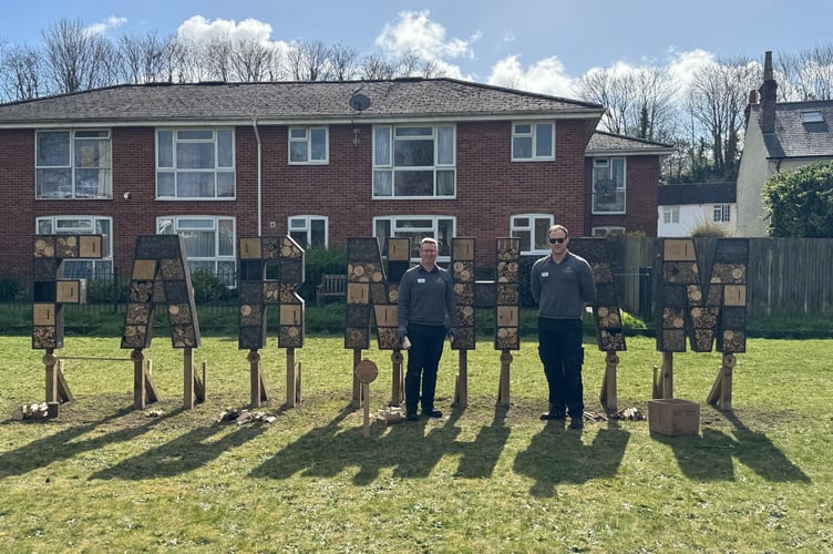 Haskins Forest Lodge's outdoor team leader Harry Ridgers (left) and colleague Lee Caddick unveil the Farnham bug house