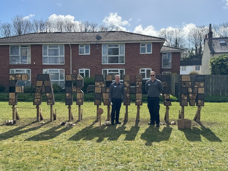 Haskins Forest Lodge's outdoor team leader Harry Ridgers (left) and colleague Lee Caddick unveil the Farnham bug house