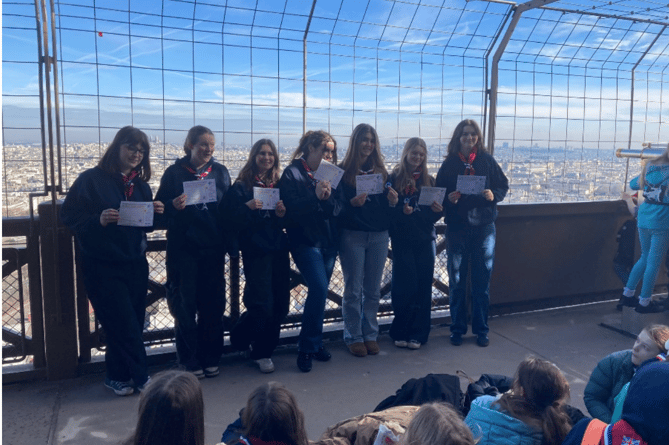 Girl Guides from the 1st Bourne Guiding unit receive their Baden Powell Challenge Awards on top of the Eiffel Tower.