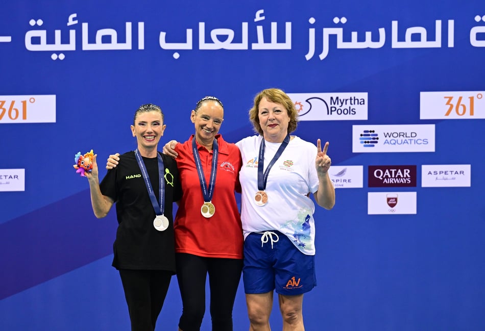 <p>Andrea Holland (centre) became a world masters champion in the solo event</p>